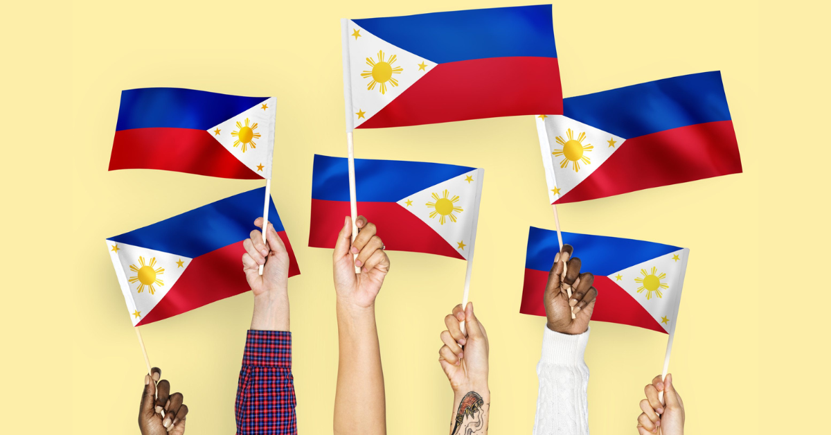 Hands waving flags of the Philippines