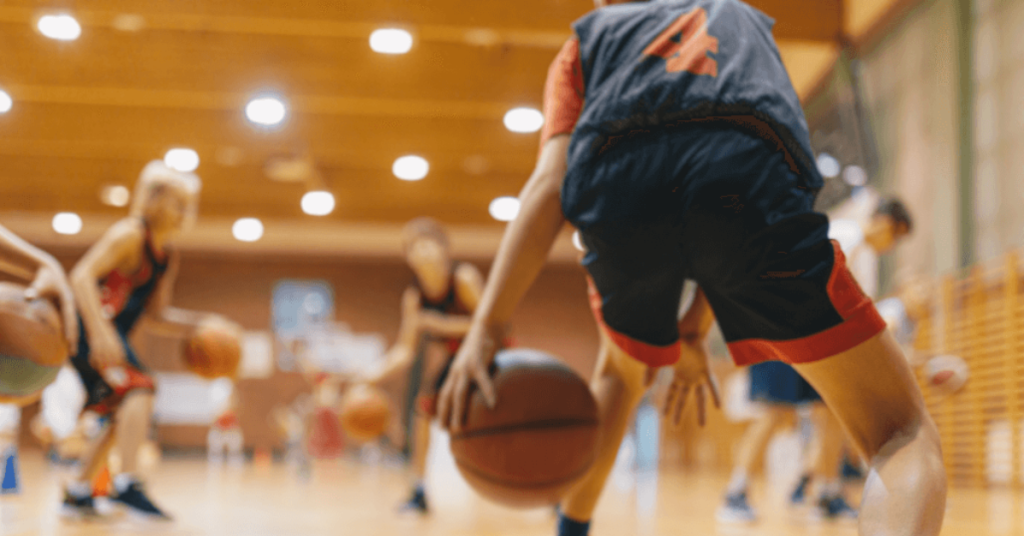 People playing basketball in an indoor basketball court