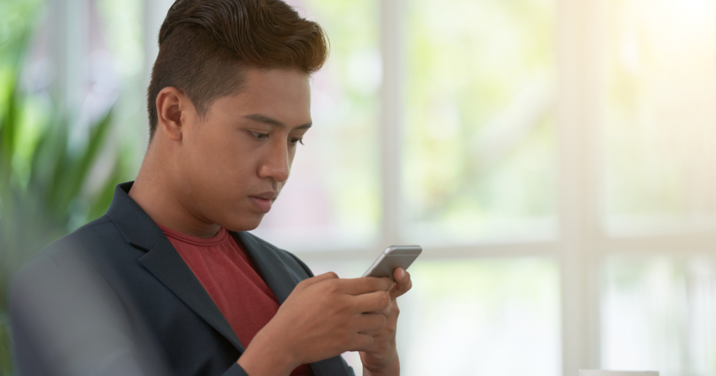 Side view. Man browsing phone