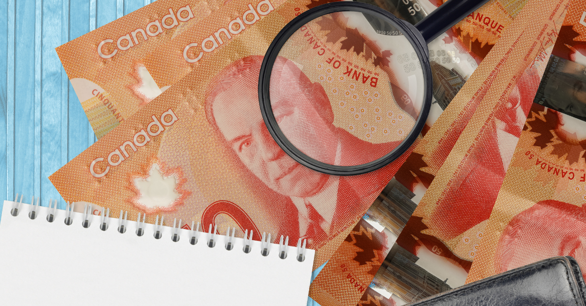 50-canadian-dollars-bills-magnifying-glass-with-black-purse-notepad