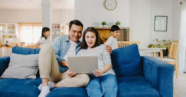 asia-family-dad-mom-sit-couch-enjoy-shopping-online-laptop-while-daughter-son-have-fun-shouting-run-around-sofa-living-room-home