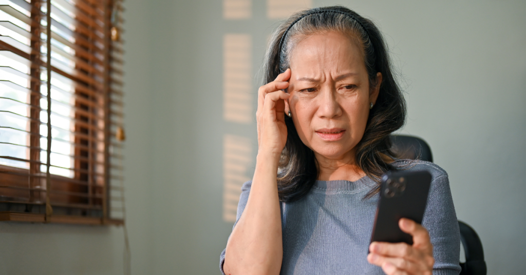 confused-asian-aged-woman-sits-her-desk-having-headache-with-technology