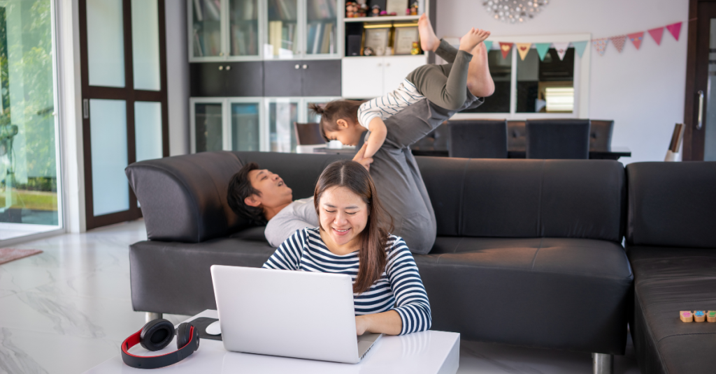 work-from-home-working-mother-father-playing-with-daughter-blur-background