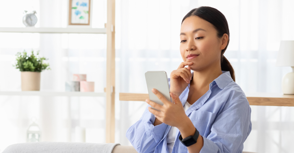 Person holding phone and looking at screen