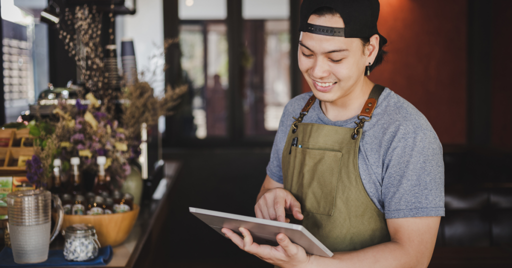 Barista holding tablet checking order from customer