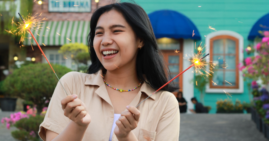 happy-young-asian-woman-holding-sparkler-celebrating-new-year-vintage-house-yard-outdoor-garden