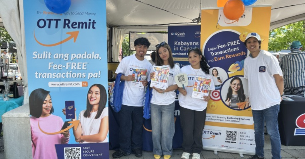 OTT Remit Team at Fun Philippines, smiling in front of booth