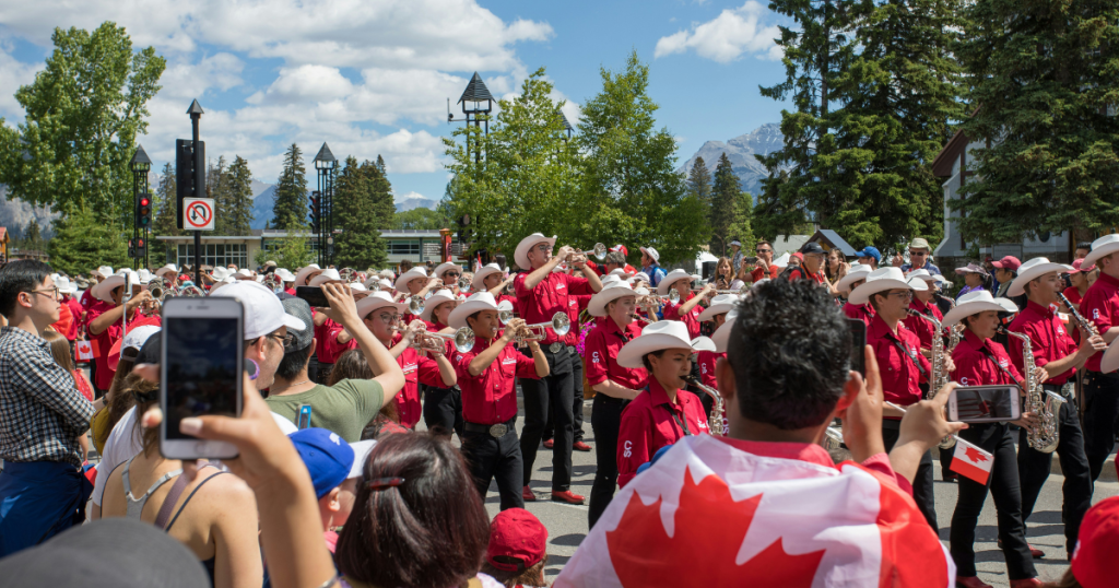 A crowd of people watching a Canada Day parade