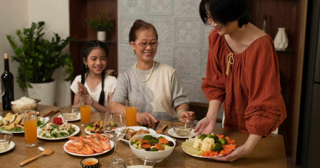 Family sitting around a table filled with food
