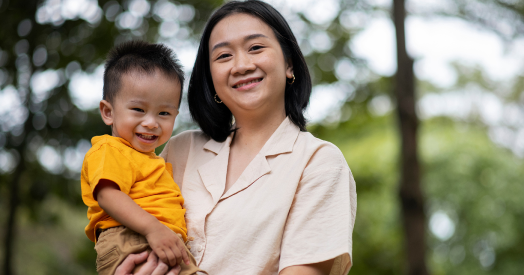 Mom holding son while outside