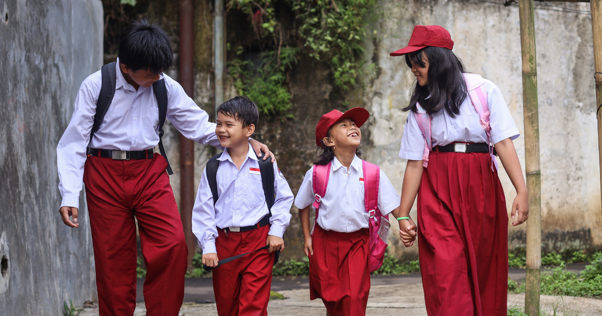 Kids in uniform walking hand-in-hand