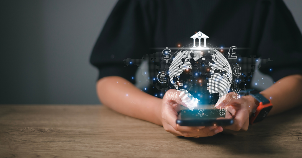 Closeup of someone holding their smartphone with an animation of a globe and currencies coming out of the screen