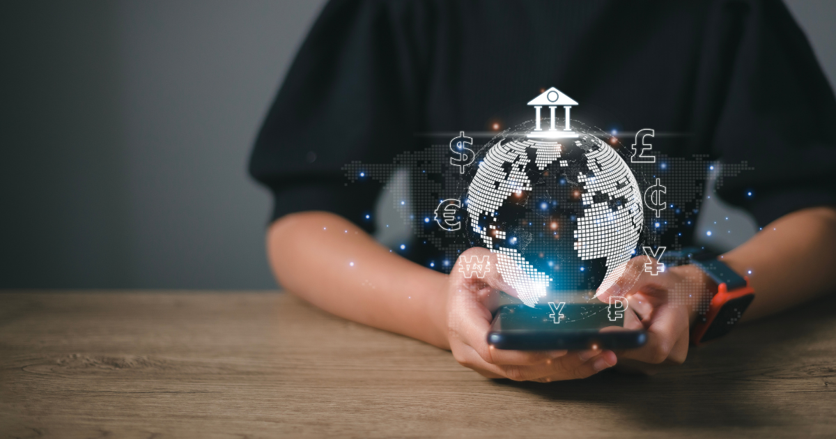 Closeup of someone holding their smartphone with an animation of a globe and currencies coming out of the screen